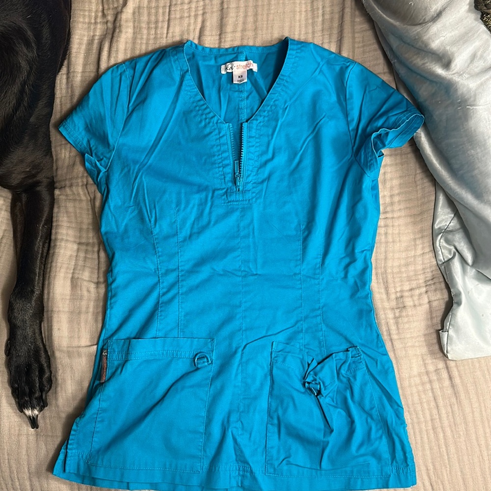Koi scrub top in turquoise. Size XS